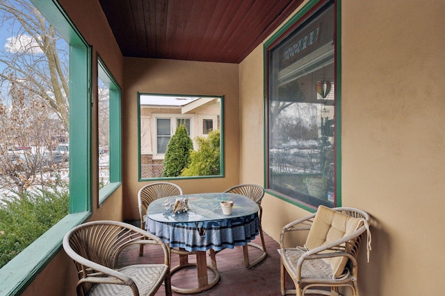 sunroom / solarium featuring wood ceiling