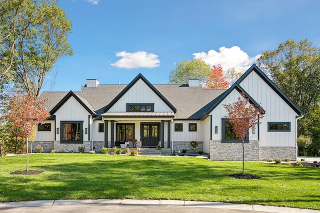 modern farmhouse style home with covered porch and a front lawn