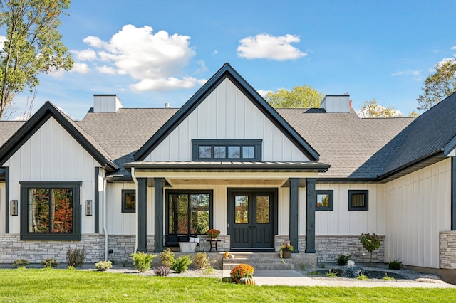 view of front of property with covered porch and a front yard