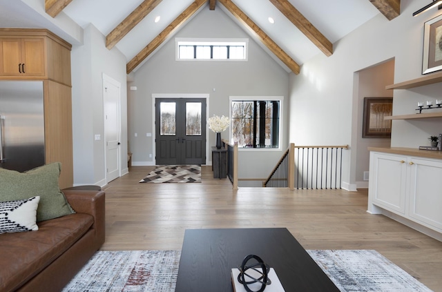 entryway featuring beamed ceiling, french doors, high vaulted ceiling, and light hardwood / wood-style flooring