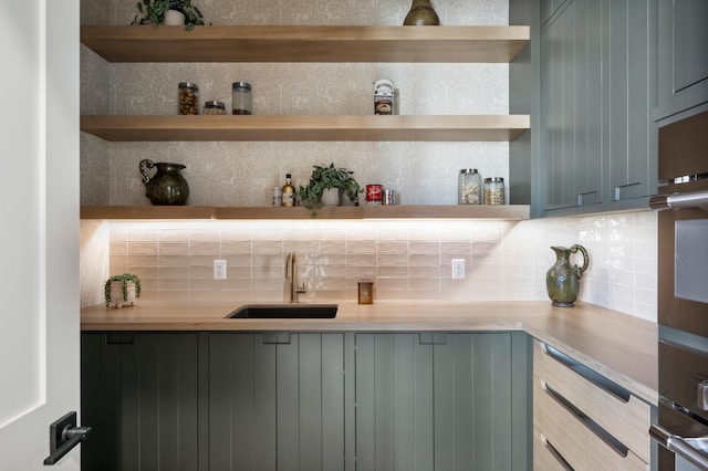 bar with gray cabinets, sink, decorative backsplash, and oven