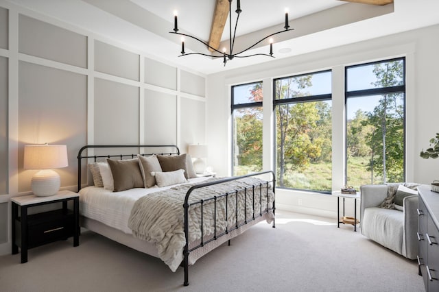 carpeted bedroom with a notable chandelier