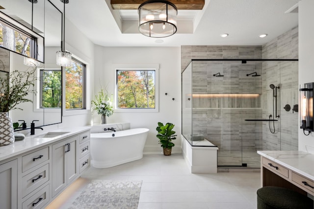 bathroom with vanity, a tray ceiling, ornamental molding, plus walk in shower, and tile patterned floors