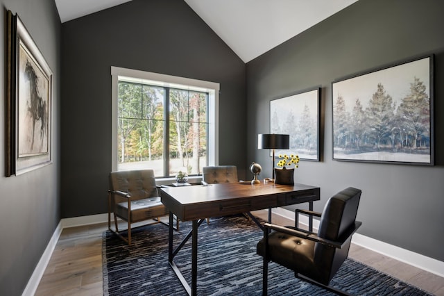 office area with hardwood / wood-style flooring and vaulted ceiling