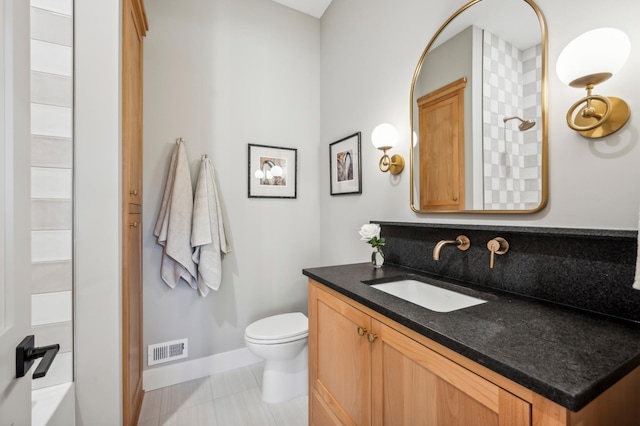 bathroom featuring vanity, walk in shower, tile patterned floors, and toilet