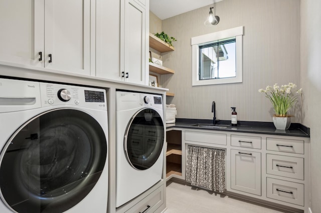 laundry room with cabinets, separate washer and dryer, and sink