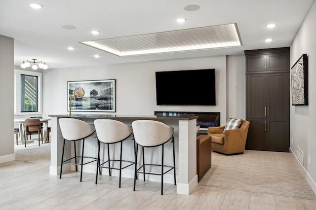 carpeted home theater room with a raised ceiling