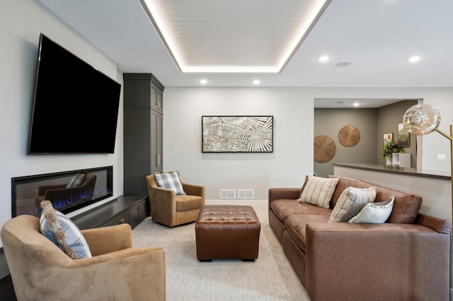 interior space featuring light carpet and a tray ceiling