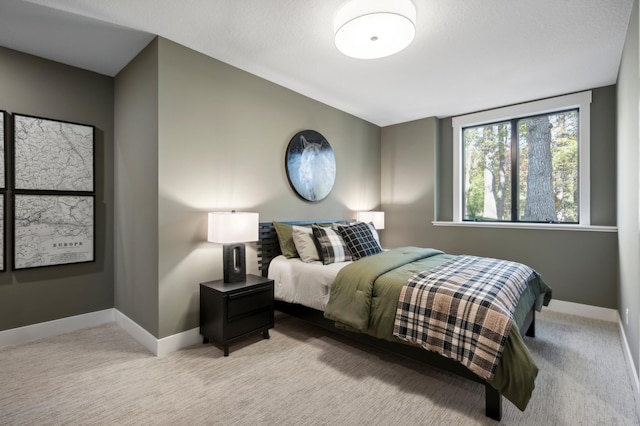 bedroom featuring light colored carpet