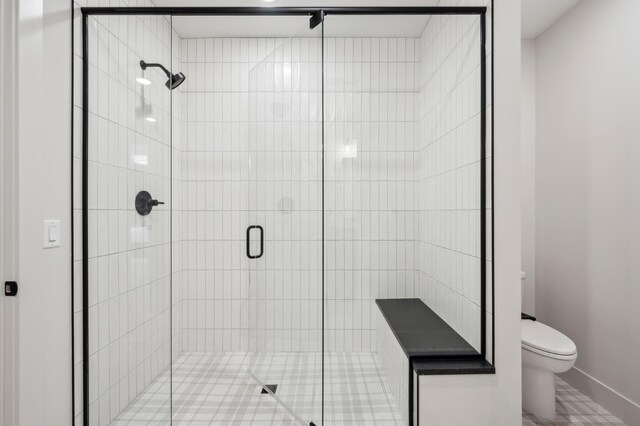 bathroom featuring walk in shower and toilet