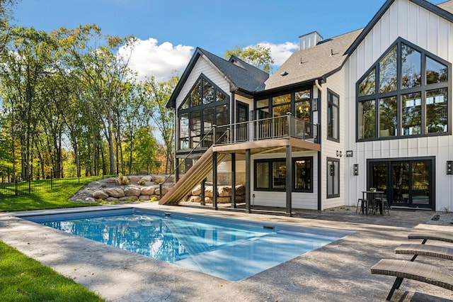 exterior space with a patio, a fenced in pool, and a sunroom