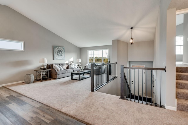 living room with lofted ceiling and a healthy amount of sunlight