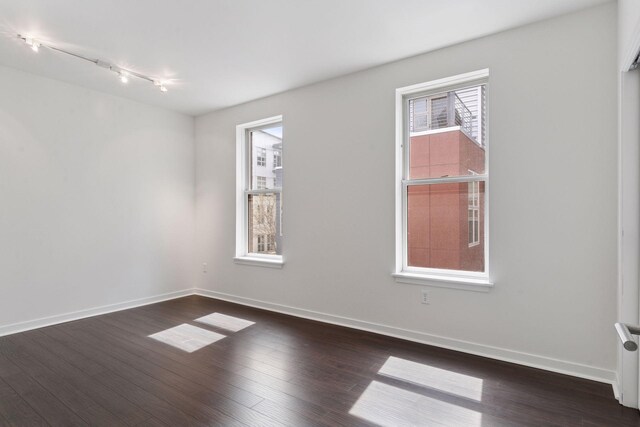 2825 Colfax Ave S Unit 211, Minneapolis, MN 55408 - spare room with track lighting, wood finished floors, and baseboards