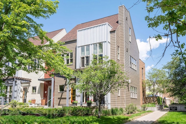 2825 Colfax Ave S Unit 211, Minneapolis, MN 55408 - townhome / multi-family property featuring a shingled roof and a pergola