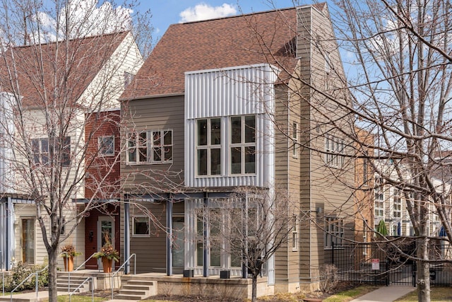 2825 Colfax Ave S Unit 211, Minneapolis, MN 55408 - view of front of home with a chimney, a gate, and a shingled roof