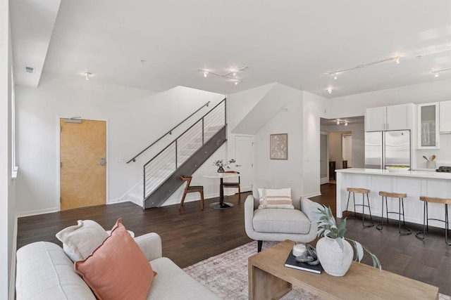 2825 Colfax Ave S Unit 211, Minneapolis, MN 55408 - living room featuring track lighting, stairway, wood finished floors, and baseboards