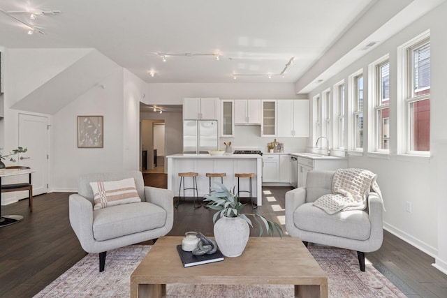 2825 Colfax Ave S Unit 211, Minneapolis, MN 55408 - living area featuring track lighting, dark wood-style floors, and baseboards