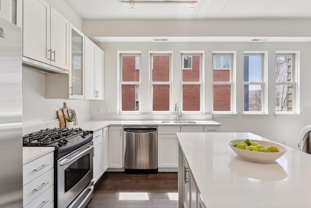 2825 Colfax Ave S Unit 211, Minneapolis, MN 55408 - kitchen featuring stainless steel appliances, a sink, light countertops, and dark wood-style flooring