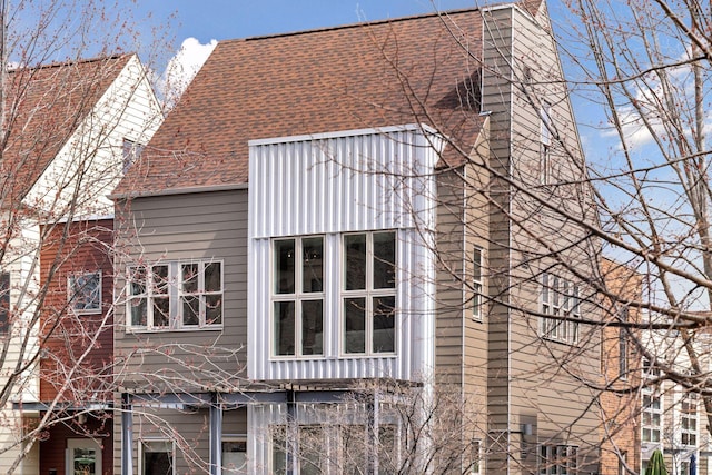 2825 Colfax Ave S Unit 211, Minneapolis, MN 55408 - view of side of home with a chimney and roof with shingles