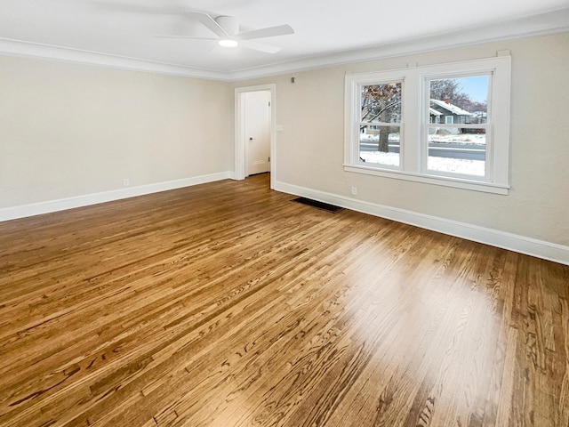 unfurnished room with hardwood / wood-style flooring, ceiling fan, and crown molding