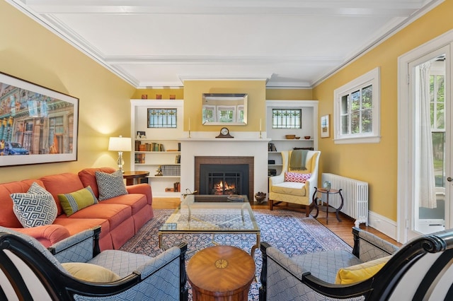 1941 James Ave S, Minneapolis, MN 55403 - living area with radiator heating unit, wood finished floors, plenty of natural light, a fireplace, and crown molding