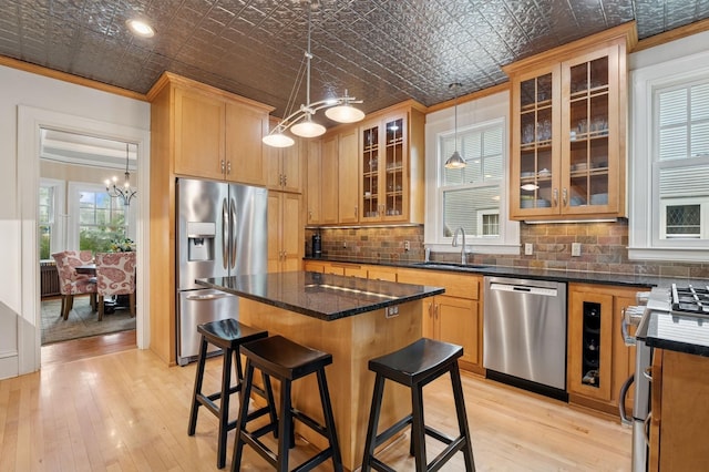 1941 James Ave S, Minneapolis, MN 55403 - kitchen featuring appliances with stainless steel finishes, a chandelier, an ornate ceiling, ornamental molding, and a sink