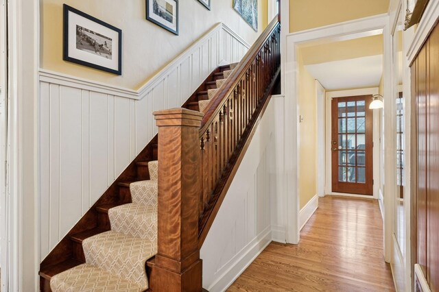1941 James Ave S, Minneapolis, MN 55403 - stairs featuring wood finished floors, a decorative wall, and wainscoting