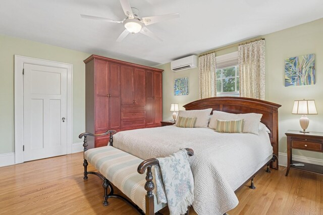 1941 James Ave S, Minneapolis, MN 55403 - bedroom featuring a wall mounted air conditioner, light wood finished floors, and baseboards