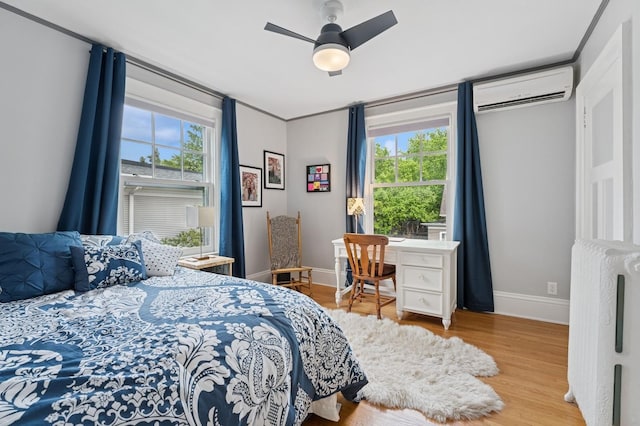 1941 James Ave S, Minneapolis, MN 55403 - bedroom with radiator heating unit, a wall mounted air conditioner, wood finished floors, and multiple windows