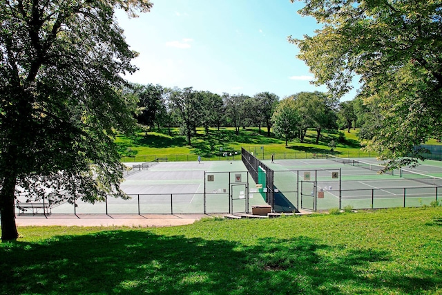 1941 James Ave S, Minneapolis, MN 55403 - view of tennis court featuring a gate and view of wooded area