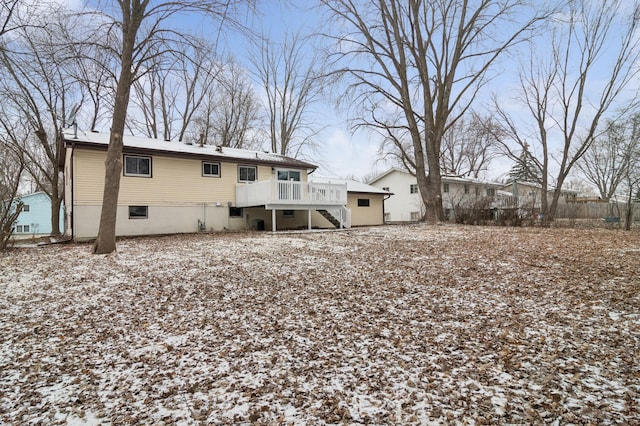 snow covered property with a wooden deck