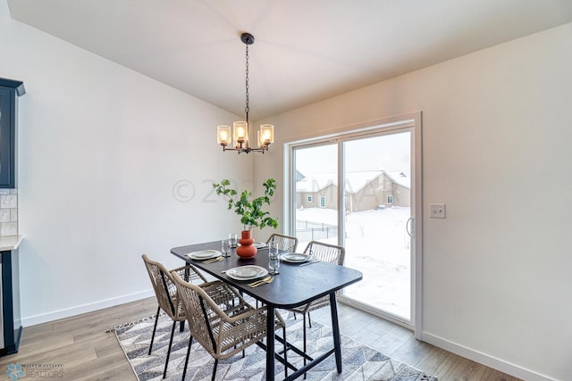 dining room featuring a notable chandelier and light hardwood / wood-style floors