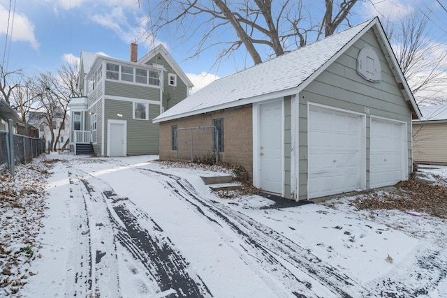 snow covered garage with central AC