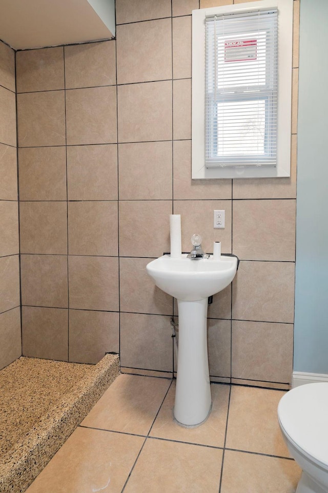 bathroom with tile patterned flooring, toilet, tile walls, and tasteful backsplash