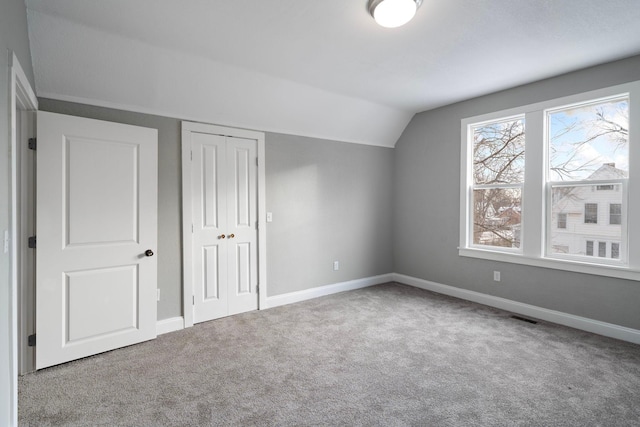 additional living space with carpet and vaulted ceiling