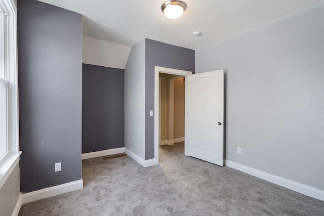 unfurnished bedroom with light carpet