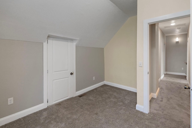 additional living space with lofted ceiling and carpet floors