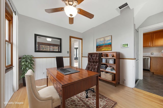 home office with ceiling fan and light hardwood / wood-style flooring