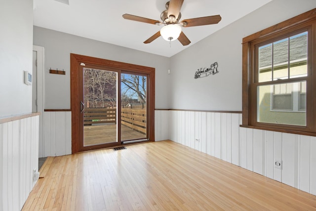 spare room featuring ceiling fan and light hardwood / wood-style flooring