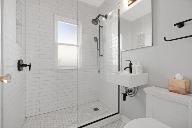 bathroom featuring an enclosed shower, toilet, and sink