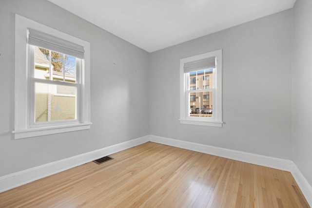 spare room featuring light hardwood / wood-style flooring