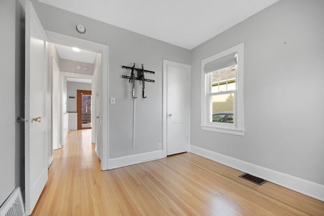 unfurnished room with light wood-type flooring