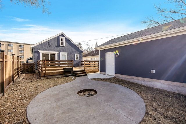 view of patio / terrace with a deck and an outdoor fire pit