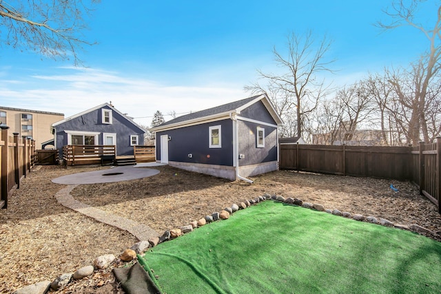 rear view of property with a patio area and a wooden deck