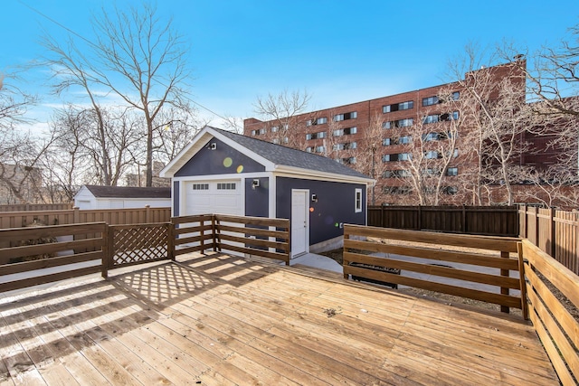 deck with a garage and an outbuilding