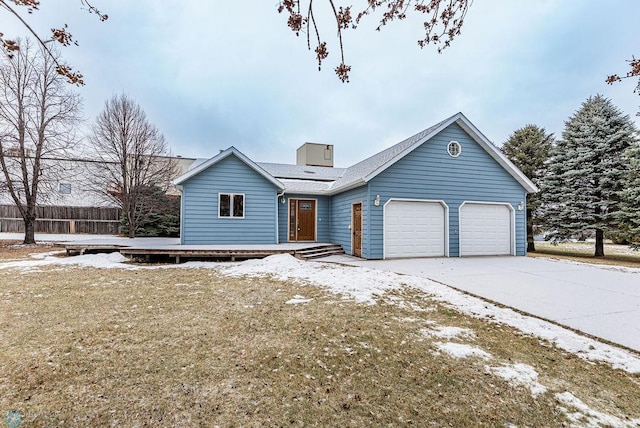 view of front of house featuring a garage, driveway, and a deck