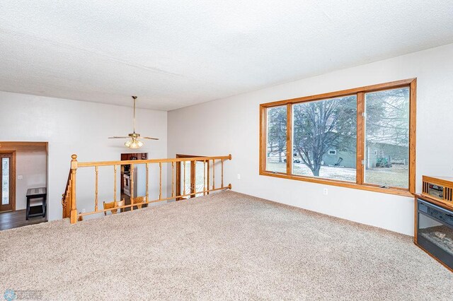 carpeted spare room featuring a textured ceiling