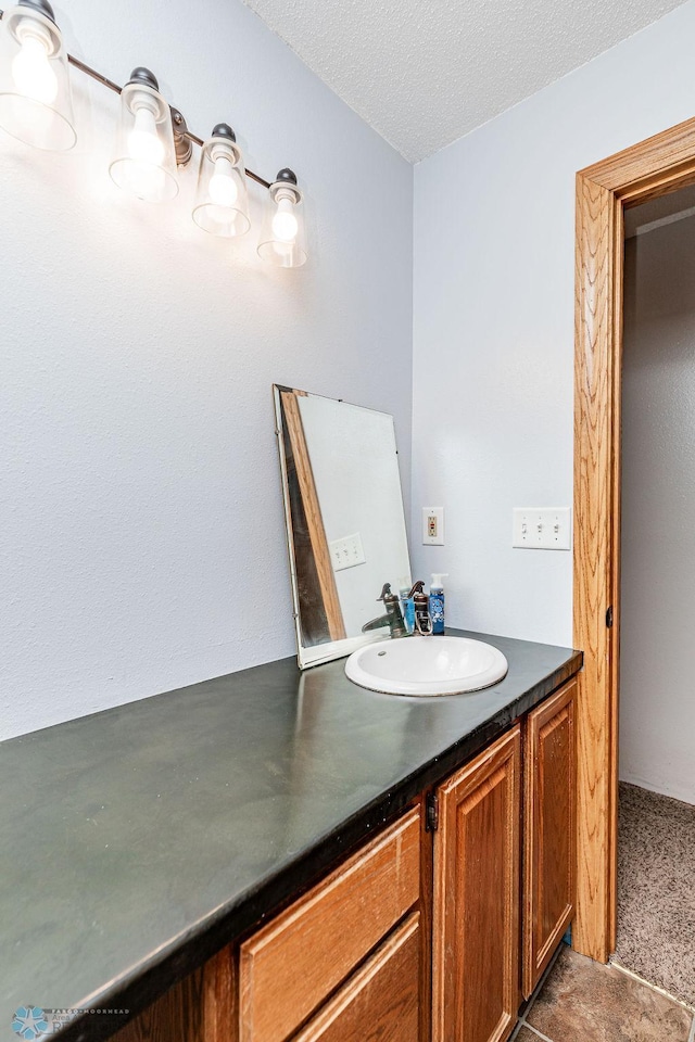 bathroom with a textured ceiling and vanity