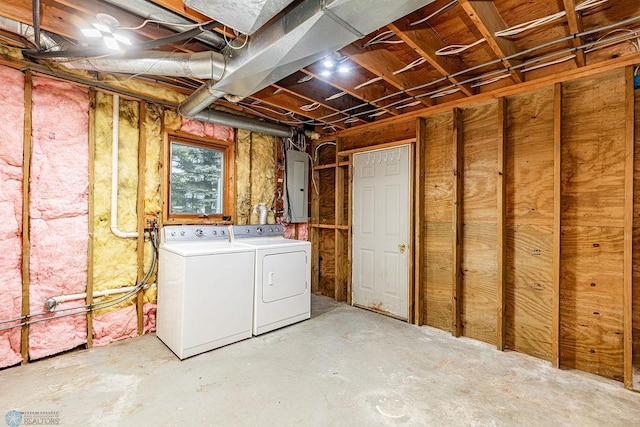 basement featuring washing machine and dryer and electric panel