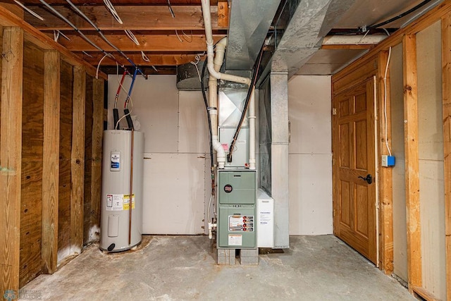 utility room featuring heating unit and electric water heater